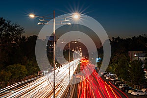 Blurred car traffic light at night city. Traffic jam in evening rush hour.