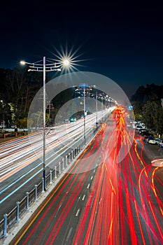 Blurred car traffic light at night city. Traffic jam in evening rush hour.