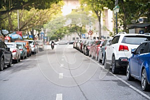 Blurred cars parked on the urban street side