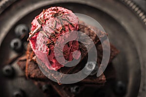 Blurred chocolate brownie with blueberry and ice cream on the vintage plate