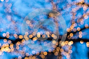 Blurred Christmas tree lights with blue sky