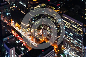 Blurred city light in aerial view. Abstract bokeh defocused background urban night building light at business center bangkok in