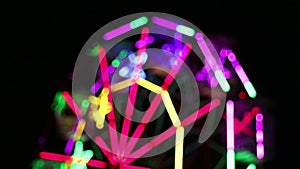Blurred colorful ferris wheel at night fun fair