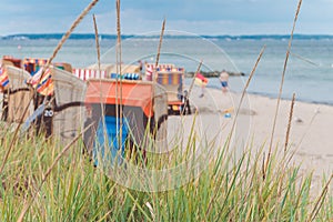 Blurred colorful roofed chairs on sandy beach in Travemunde. Germany