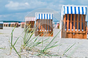 Blurred colourful beach roofed chairs on sandy beach in Travemunde, Germany