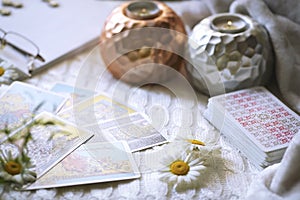 Blurred composition with Tarot cards, candles and flowers