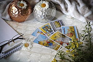 Blurred composition with Tarot cards, candles and flowers