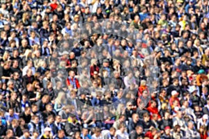 Blurred crowd of spectators on a stadium tribune