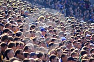 Blurred crowd of spectators on a stadium tribune