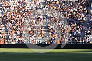 Blurred crowd of spectators on a stadium tribune at a sporting e