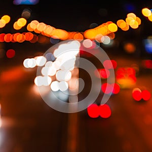 Blurred defocused car lights at night. Abstract colorful blurred background of night city with lights reflections