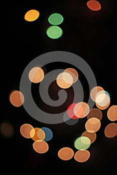 Blurred defocused christmas light lights bokeh background. Colorful red yellow blue green de focused glittering pattern