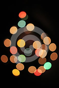 Blurred defocused christmas light lights bokeh background. Colorful red yellow blue green de focused glittering pattern