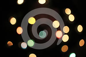 Blurred defocused christmas light lights bokeh background. Colorful red yellow blue green de focused glittering pattern