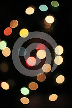 Blurred defocused christmas light lights bokeh background. Colorful red yellow blue green de focused glittering pattern