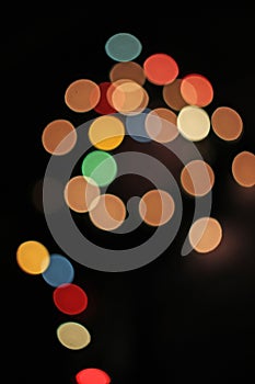 Blurred defocused christmas light lights bokeh background. Colorful red yellow blue green de focused glittering pattern