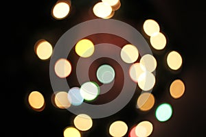 Blurred defocused christmas light lights bokeh background. Colorful red yellow blue green de focused glittering pattern