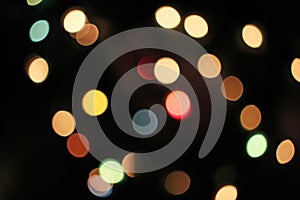 Blurred defocused christmas light lights bokeh background. Colorful red yellow blue green de focused glittering pattern