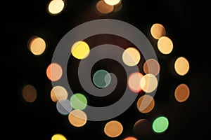 Blurred defocused christmas light lights bokeh background. Colorful red yellow blue green de focused glittering pattern