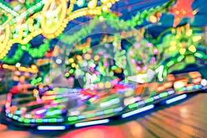 Blurred defocused lights at luna park carousel roundabout