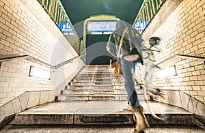 Blurred defocused man with bike going out from Rosa Luxemburg subway station in Berlin