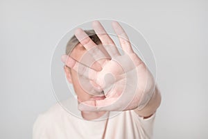 Blurred and defocused, a man showing palm hand, concept of denial