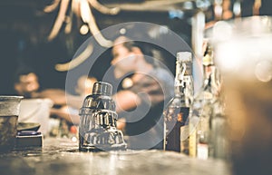 Blurred defocused side view of barman at cocktail bar