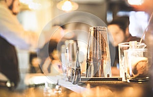 Blurred defocused side view of barman preparing drink at cocktail bar