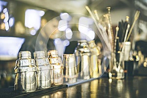 Blurred defocused view of barman preparing drinks at speakeasy cocktail bar on happy hour - Mixology concept with blurry bartender photo