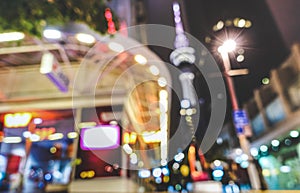 Blurred defocused view of urban nightscape at city center in Auckland capital of New Zealand - Abstract bokeh background by night