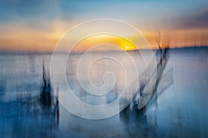 Blurred effect of the sea and sunset. Intentional camera movement creating a dreamy background.