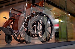 Blurred empty wheelchair near lift in private hospital for service patient and disabled people. Medical equipment in hospital for