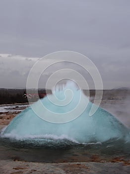 Blurred. The eruption of the Strokkur geyser in the southwestern part of Iceland in a geothermal area near the river Hvitau