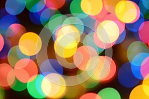 Blurred festive colorful lights over black useful as background. All main colors included. Red, yellow, green and blue