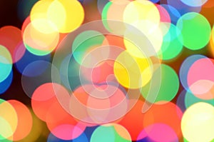 Blurred festive colorful lights over black useful as background. All main colors included. Red, yellow, green and blue