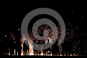 Blurred focus silhouette people looking show of the man spin the fire on beach