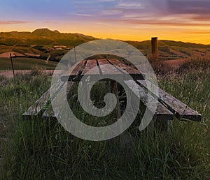 Blurred Focused Beautiful twilight picturesque farmland view of Middle Valley, Canterbury, New Zealand. Wooden bench and table in