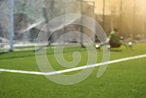 Blurred football background: goalkeeper catches the ball during game moment