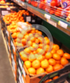 Blurred fresh fruits and vegetables at retail store. Abstract background of supermarket. Grocery market blurred background. Fruits