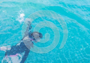 Blurred A girl learning to diving under swimming pool water background