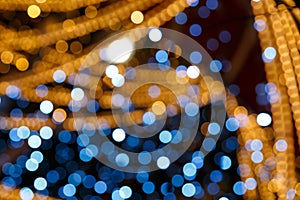 Blurred gold and blue bokeh texture. Multicolored circles