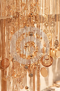 blurred gold jewelry necklace chains for background, panel gold shop jewelry store for seller products and gold showcase