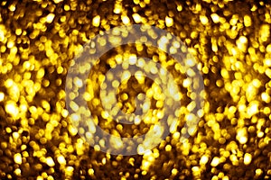 Blurred golden shiny glitter bokeh background, defocused yellow shimmer backdrop design, gold shining round bubbles blur effect