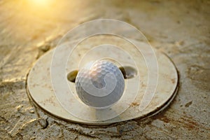 Blurred golf ball is on barrier in golf course