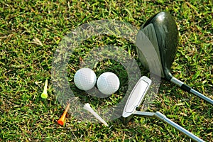Blurred golf club and golf ball close up in grass field