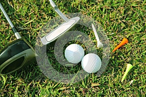 Blurred golf club and golf ball close up in grass field with sunset. Golf ball close up in golf coures