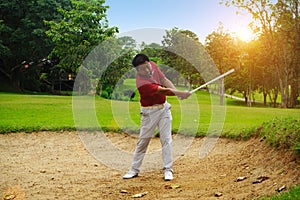 Blurred golfer playing golf in beautiful golf course in the evening golf course with sunshine