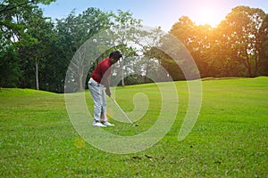 Blurred golfer playing golf in beautiful golf course in the evening golf course with sunshine