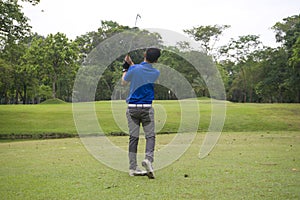 Blurred golfers are playing golf in the evening golf course in thailand. Golf ball and golf club in beautiful golf course at