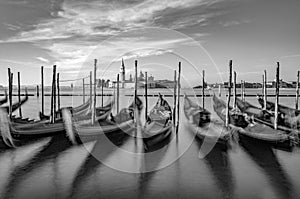 Blurred gondolas at San Marco with view in early morning to island San Georgio Maggiore in Venice